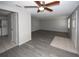 Large living room features ceiling fan, new floors, and light neutral color at 3603 Darlington Rd, Holiday, FL 34691