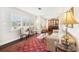 Bright living room with shuttered windows, decorative rug, and stylish furniture at 4027 Benson N Ave, St Petersburg, FL 33713