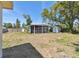 Backyard featuring a large screened porch, storage shed, and wood fence at 4030 Marlin Se Dr, St Petersburg, FL 33705