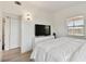 Cozy bedroom featuring a comfy bed, integrated media center, and natural light from a sunny window at 4030 Marlin Se Dr, St Petersburg, FL 33705