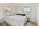 Comfortable bedroom with a full bed, side table and stylish rug bathed in natural light from two bright windows at 4030 Marlin Se Dr, St Petersburg, FL 33705