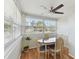 Dining area with large windows and a ceiling fan at 4030 Marlin Se Dr, St Petersburg, FL 33705