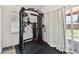 Home gym area featuring modern exercise equipment, natural light, and backyard view at 4030 Marlin Se Dr, St Petersburg, FL 33705