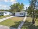 A charming single story home with a well-manicured lawn, complemented by mature trees and a welcoming driveway at 4030 Marlin Se Dr, St Petersburg, FL 33705