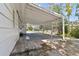 Side yard view with a carport, brick features, and white lattice work at 4030 Marlin Se Dr, St Petersburg, FL 33705