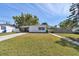 Charming single-story home with a well-manicured lawn and quaint carport under a clear blue sky at 4030 Marlin Se Dr, St Petersburg, FL 33705