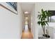 Hallway has light colored floors and walls, with a peek into the back yard at 4030 Marlin Se Dr, St Petersburg, FL 33705