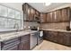 Kitchen with stainless steel appliances, wood cabinets, and mosaic backsplash at 4030 Marlin Se Dr, St Petersburg, FL 33705
