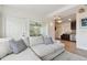 Spacious living room with stylish sectional, flowing into the kitchen and sunroom, perfect for entertaining at 4030 Marlin Se Dr, St Petersburg, FL 33705