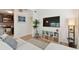 Stylish living room featuring a large TV, plant, and seamless transition to the modern, well-equipped kitchen at 4030 Marlin Se Dr, St Petersburg, FL 33705