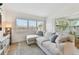 Inviting living room with ample seating, natural light, and a view into the sunroom through large windows at 4030 Marlin Se Dr, St Petersburg, FL 33705