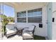 Charming porch with comfy seating, perfect for relaxing and enjoying the view with the front door nearby at 4030 Marlin Se Dr, St Petersburg, FL 33705