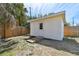 Storage Shed featuring fresh paint, a wood ramp, and access door at 4030 Marlin Se Dr, St Petersburg, FL 33705