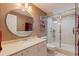 Modern bathroom with a glass-enclosed shower, sleek vanity, and round mirror, offering a spa-like experience at 487 Pinellas Bayway S # 6, Tierra Verde, FL 33715