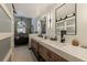 Elegant bathroom boasting double vanities, a modern chandelier, and a luxurious soaking tub for ultimate comfort at 487 Pinellas Bayway S # 6, Tierra Verde, FL 33715