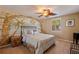 Bright bedroom with a ceiling fan, mural wall, and a plush bed offering a relaxing retreat at 487 Pinellas Bayway S # 6, Tierra Verde, FL 33715