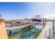 Several boats are secured on lifts, illustrating the waterfront lifestyle and easy access to boating at 487 Pinellas Bayway S # 6, Tierra Verde, FL 33715