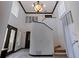 Spacious two-story foyer featuring a staircase, decorative lighting, and an elegant entry at 487 Pinellas Bayway S # 6, Tierra Verde, FL 33715