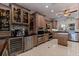 Gourmet kitchen with a wine refrigerator and cooler, granite countertops, and custom wood cabinets at 487 Pinellas Bayway S # 6, Tierra Verde, FL 33715