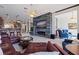 Comfortable living room with sliding glass doors to a lanai, stone accent wall, and fireplace at 487 Pinellas Bayway S # 6, Tierra Verde, FL 33715