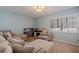 Cozy living room featuring comfortable seating, natural light, and plantation shutters at 487 Pinellas Bayway S # 6, Tierra Verde, FL 33715