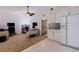 Versatile living space with a desk area, seating, and a view into an adjacent room with a kitchen at 487 Pinellas Bayway S # 6, Tierra Verde, FL 33715