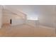 Spacious, carpeted loft area with sloped ceilings and neutral decor offers versatility as a bonus room or study at 487 Pinellas Bayway S # 6, Tierra Verde, FL 33715