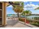 Inviting patio area with waterfront views and lush tropical landscaping at 487 Pinellas Bayway S # 6, Tierra Verde, FL 33715