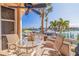 Charming patio with waterfront views, a ceiling fan, and outdoor seating at 487 Pinellas Bayway S # 6, Tierra Verde, FL 33715