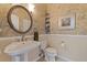 Stylish powder room featuring unique wallpaper, a pedestal sink, and classic fixtures at 487 Pinellas Bayway S # 6, Tierra Verde, FL 33715