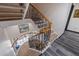 Elegant staircase with wrought iron railings and hardwood steps at 487 Pinellas Bayway S # 6, Tierra Verde, FL 33715