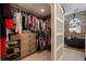 Well-organized walk-in closet leading to a bathroom with modern fixtures and a luxurious soaking tub at 487 Pinellas Bayway S # 6, Tierra Verde, FL 33715