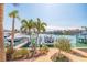 Picturesque waterfront view with lush landscaping and a private boat dock at 487 Pinellas Bayway S # 6, Tierra Verde, FL 33715