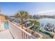 Stunning waterfront view with a private boat dock, pool and tropical landscaping for serene outdoor living at 487 Pinellas Bayway S # 6, Tierra Verde, FL 33715