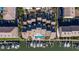 Aerial view of waterfront townhomes and boat docks with community pool in the center at 487 Pinellas Bayway S # 6, Tierra Verde, FL 33715