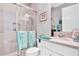 Modern bathroom with glass shower, marble countertop, and beach-themed accents at 4926 Pamplona Ct, Wimauma, FL 33598