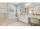 Bright bathroom with marble tile, soaking tub, and vanity area at 4926 Pamplona Ct, Wimauma, FL 33598