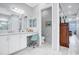Bathroom with white cabinets, quartz countertop, and a makeup vanity at 4926 Pamplona Ct, Wimauma, FL 33598