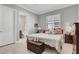 Cozy bedroom with natural light, plush bedding, and convenient ensuite bathroom access at 4926 Pamplona Ct, Wimauma, FL 33598