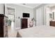 Bedroom with hardwood floors, a dresser, and a flatscreen TV at 4926 Pamplona Ct, Wimauma, FL 33598