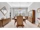 Elegant dining room with stylish chandelier, large window, and hardwood floors for entertaining guests at 4926 Pamplona Ct, Wimauma, FL 33598