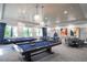 Entertaining game room with billiards and card tables, stylish pendant lighting, and comfortable seating, perfect for recreation at 4926 Pamplona Ct, Wimauma, FL 33598