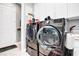 Laundry room featuring modern washer and dryer units with white cabinets at 4926 Pamplona Ct, Wimauma, FL 33598