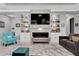 Spacious living room with custom built-ins and a modern fireplace at 4926 Pamplona Ct, Wimauma, FL 33598
