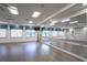 Bright yoga studio with hardwood floors, mirrored wall, and large windows, ideal for fitness and wellness activities at 4926 Pamplona Ct, Wimauma, FL 33598