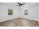 Bedroom features new hardwood floors and fresh paint with a new ceiling fan and two windows at 501 W Bird St, Tampa, FL 33604