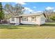 Attractive home with neat landscaping, dark trim, wooden shutters, and a charming pink front door at 501 W Bird St, Tampa, FL 33604