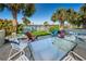 Outdoor patio seating features beautiful pool views surrounded by tropical landscaping at 507 Windrush Bay Dr # 507, Tarpon Springs, FL 34689