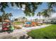 Recreational area with colorful kayaks stored neatly near waterfront, lush greenery, and blue skies at 5111 Coquina Key Se Dr # C, St Petersburg, FL 33705