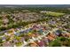 An aerial view showcases the home's location within a quiet, tree-lined residential neighborhood at 5123 Whispering Leaf Trl, Valrico, FL 33596